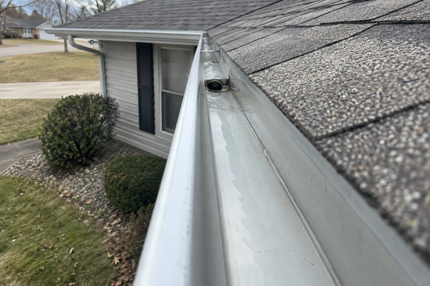 Cleared gutter channel with an open downspout outlet